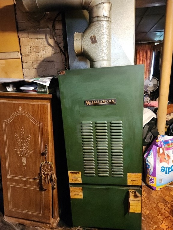 utility room featuring heating unit