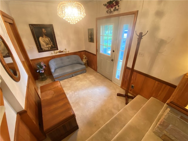 foyer entrance with wooden walls and a notable chandelier