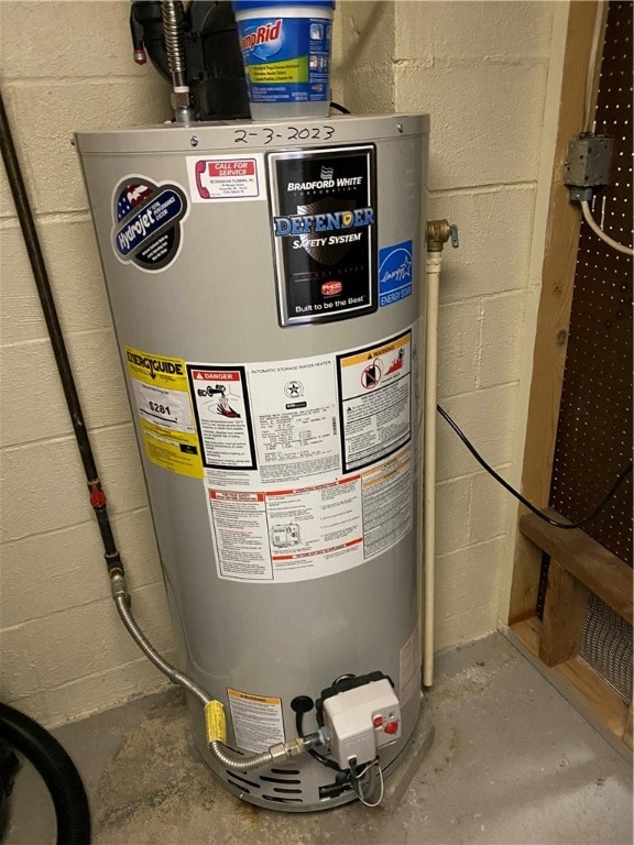 utility room featuring gas water heater