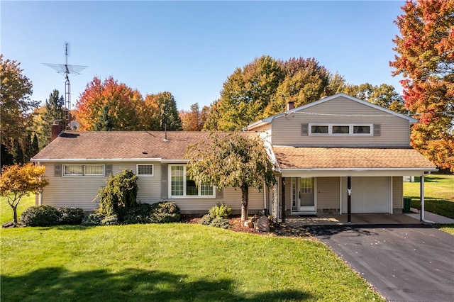 view of front of home with a front yard and a garage