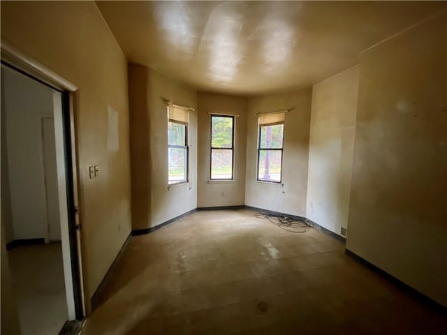spare room with baseboards