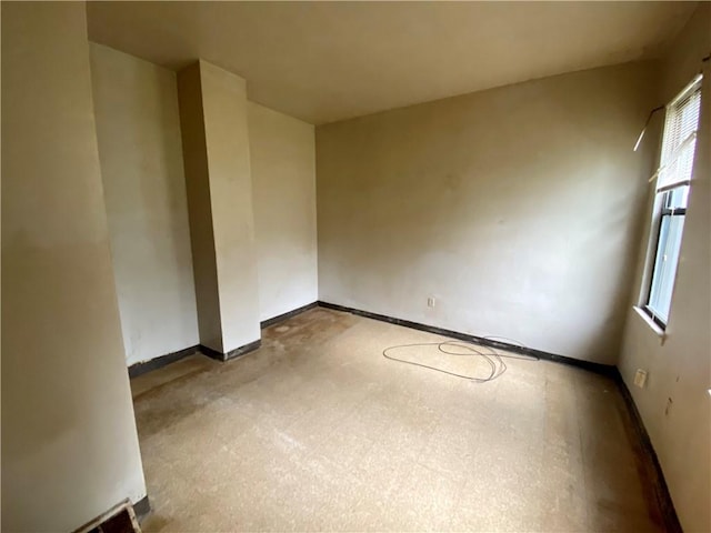 spare room featuring baseboards
