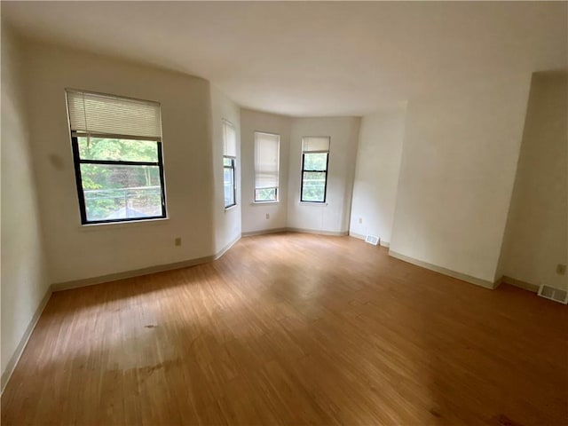 spare room with light wood-style flooring and baseboards