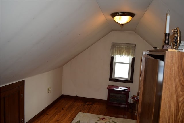 bonus room featuring vaulted ceiling and dark hardwood / wood-style flooring