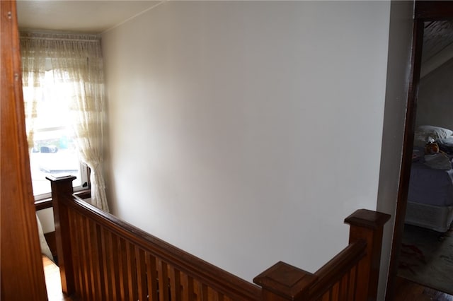 corridor with hardwood / wood-style flooring