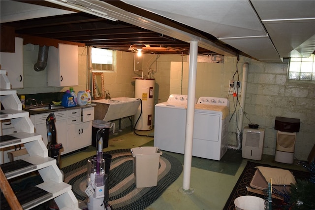 basement featuring washing machine and dryer, plenty of natural light, water heater, and sink