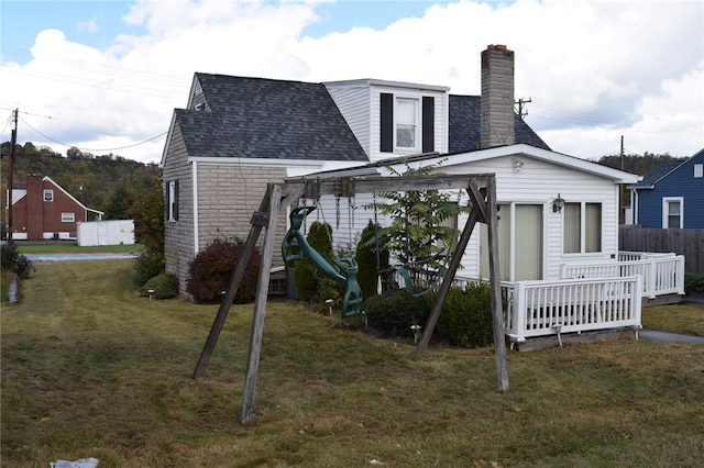 rear view of house featuring a lawn