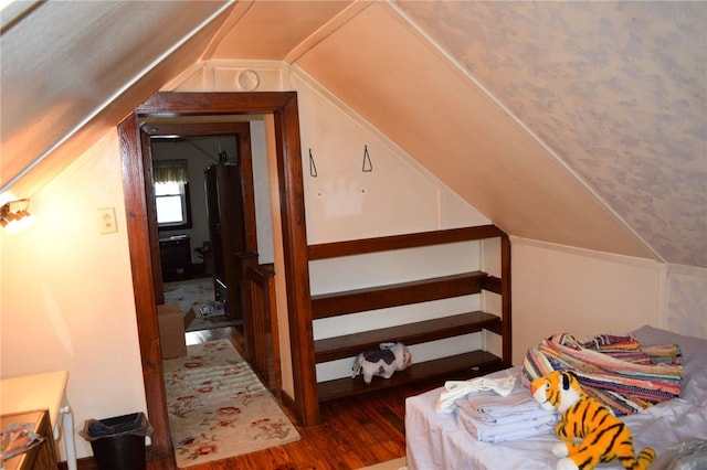 bonus room with lofted ceiling and dark hardwood / wood-style flooring