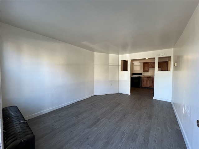 unfurnished living room with dark hardwood / wood-style floors