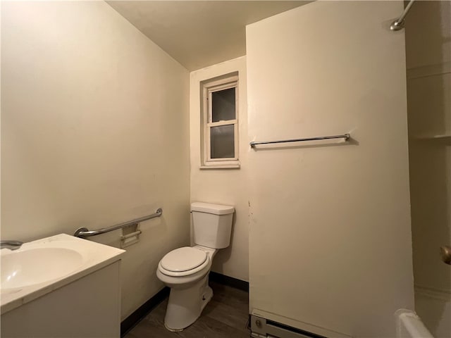 bathroom featuring hardwood / wood-style flooring, a shower, vaulted ceiling, toilet, and vanity