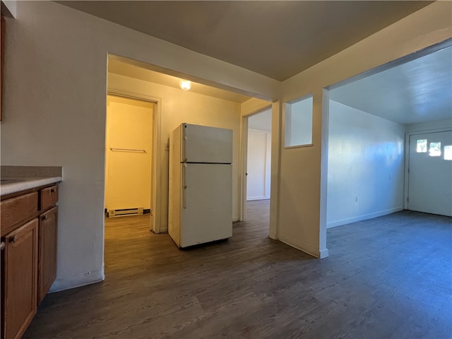 interior space with hardwood / wood-style flooring and a baseboard heating unit