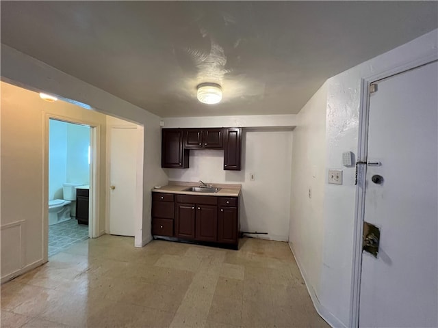 kitchen with dark brown cabinetry and sink