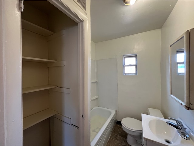 bathroom with vanity, toilet, and a bath