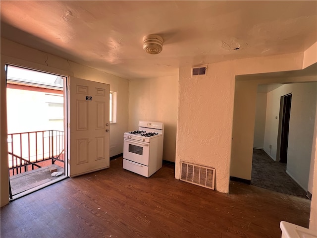 kitchen featuring dark hardwood / wood-style floors and white gas stove