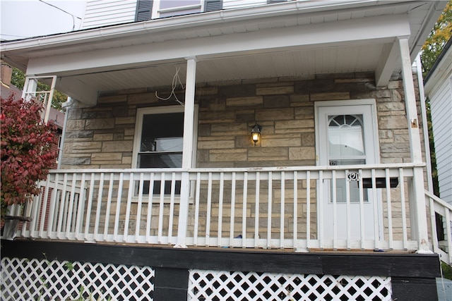 view of exterior entry with covered porch