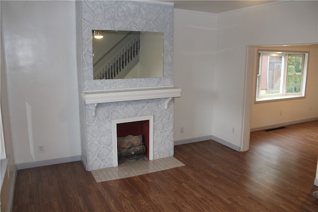 unfurnished living room with a fireplace, dark hardwood / wood-style floors, and ornamental molding