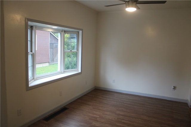 spare room featuring ceiling fan and dark hardwood / wood-style floors