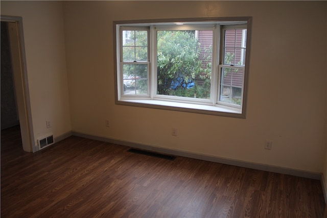 spare room with dark hardwood / wood-style floors