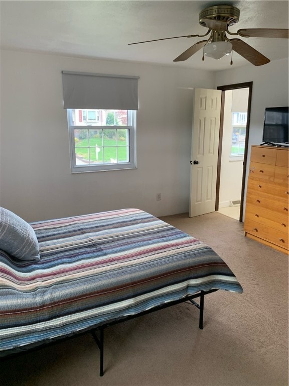 bedroom with light carpet and ceiling fan