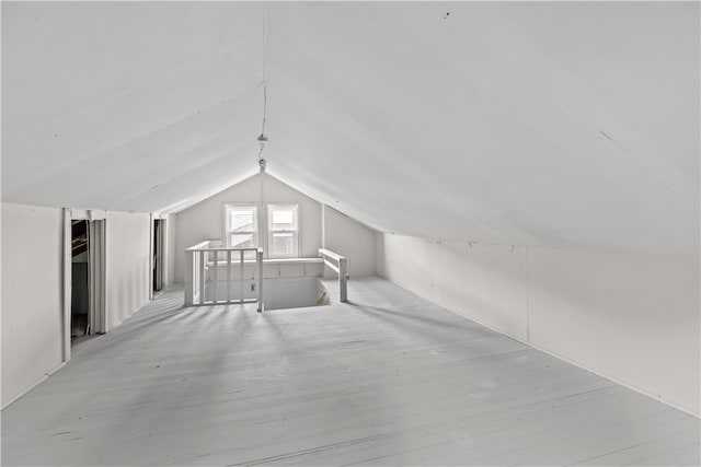 additional living space featuring lofted ceiling