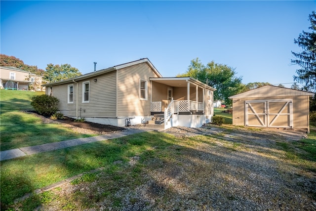 view of front of house with a front lawn and a shed