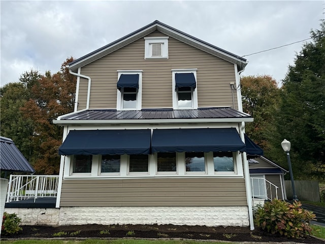 rear view of property with a porch