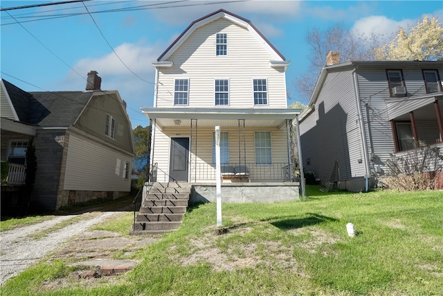 view of front facade with a front lawn and a porch