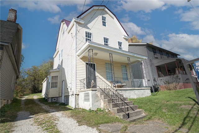 view of front of home with covered porch and a front yard