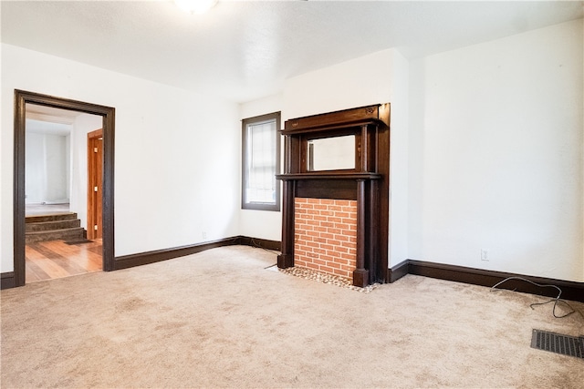 unfurnished living room featuring carpet