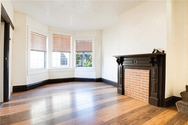 unfurnished living room with hardwood / wood-style flooring