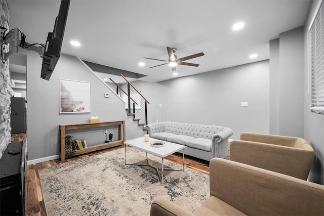 living room with ceiling fan and dark hardwood / wood-style floors