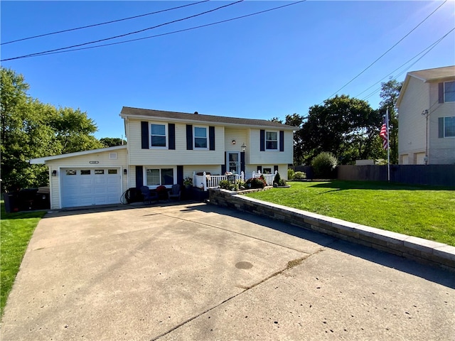 bi-level home featuring a garage and a front yard