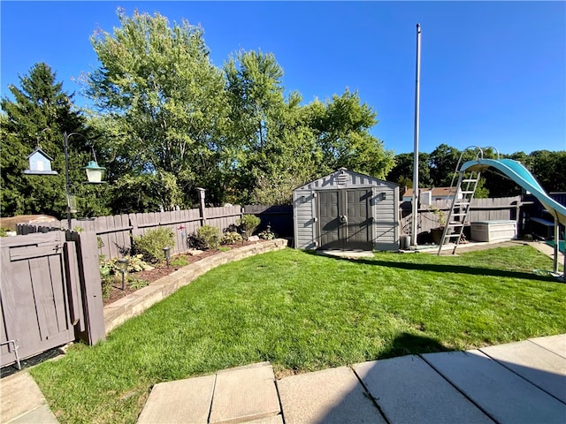 view of yard featuring a playground and a storage unit