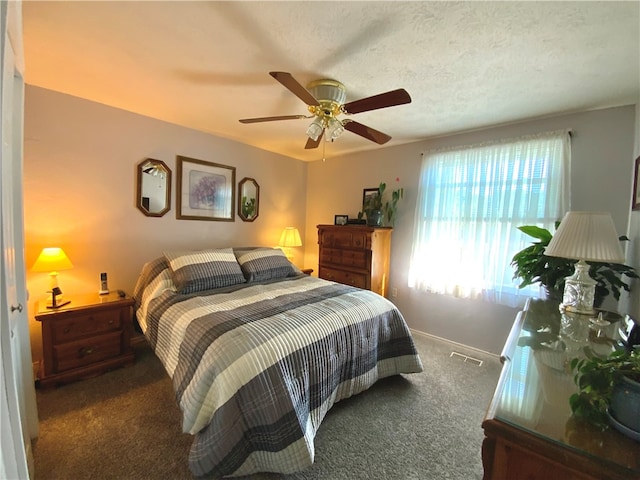 carpeted bedroom with a textured ceiling and ceiling fan