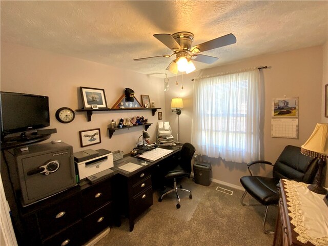 home office with carpet, a textured ceiling, and ceiling fan