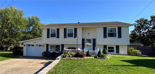 split foyer home with a garage and a front lawn