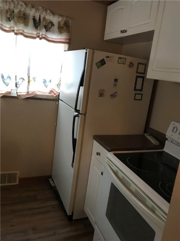 kitchen with white cabinetry, white electric stove, and dark hardwood / wood-style flooring