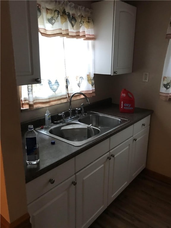 kitchen with white cabinets, sink, and dark hardwood / wood-style flooring