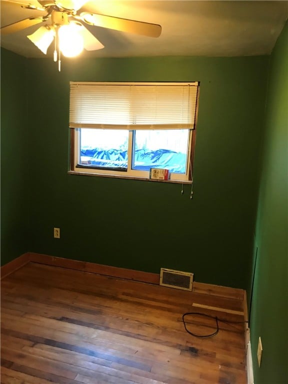 unfurnished room featuring ceiling fan and wood-type flooring