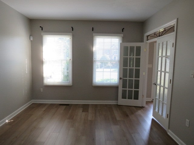 interior space with french doors and dark hardwood / wood-style flooring