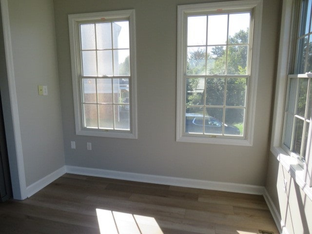 spare room featuring dark wood-type flooring