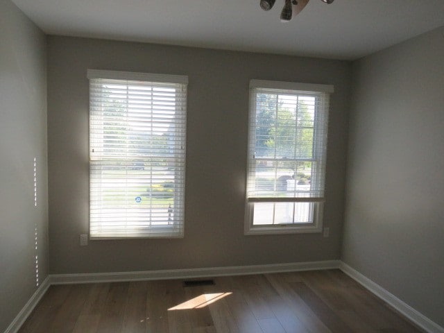 spare room featuring dark hardwood / wood-style floors