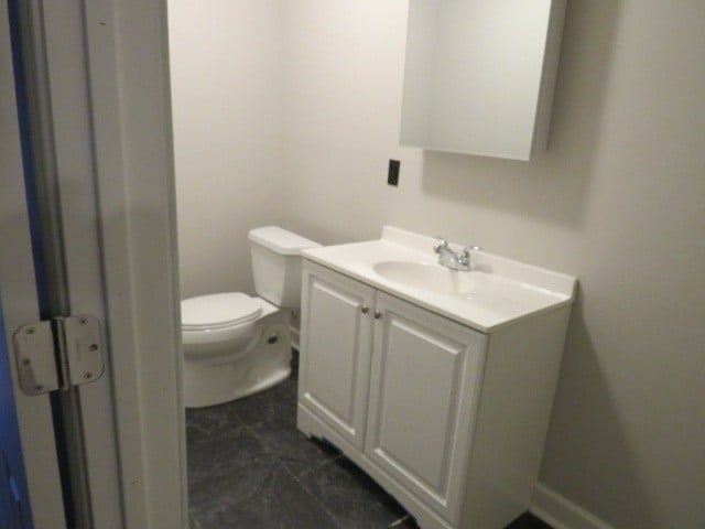 bathroom featuring vanity, toilet, and tile patterned floors