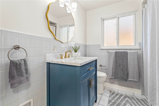 bathroom with vanity, tile walls, toilet, and tile patterned floors