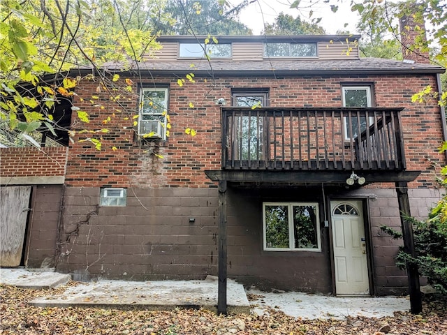 back of property featuring a balcony