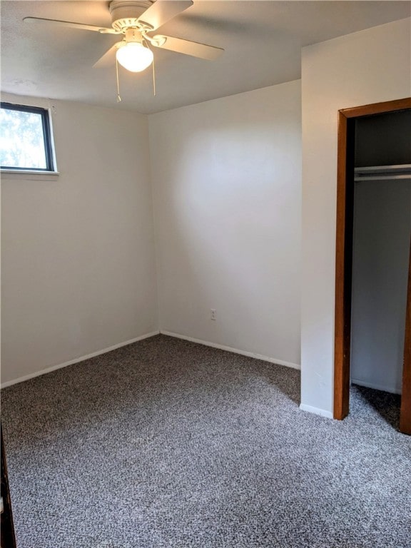 unfurnished bedroom featuring ceiling fan, carpet floors, and a closet