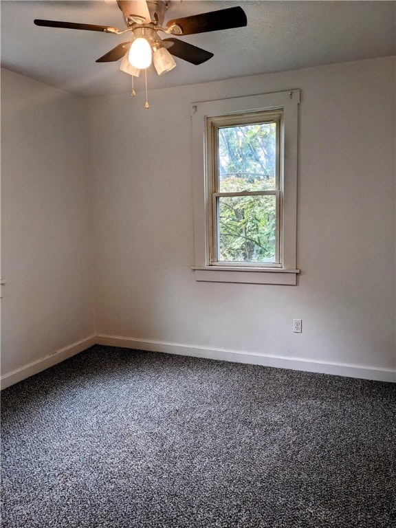 spare room featuring ceiling fan and carpet flooring