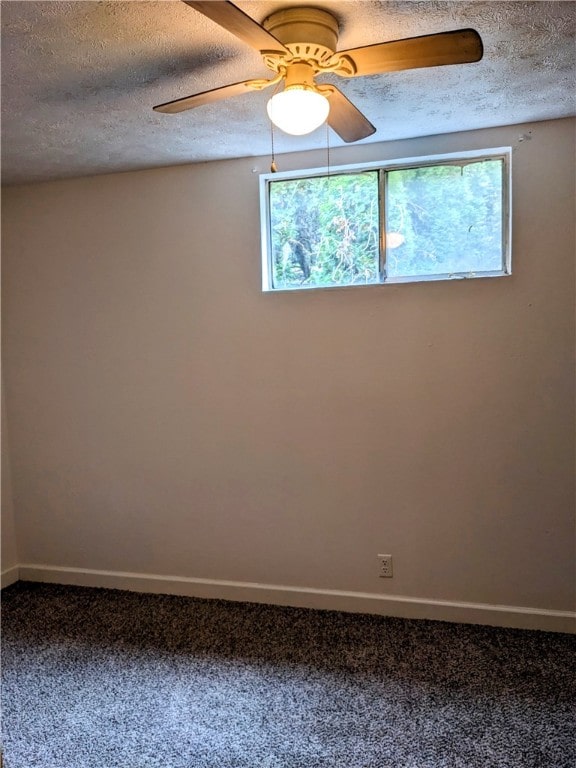 carpeted spare room with ceiling fan, a textured ceiling, and a wealth of natural light