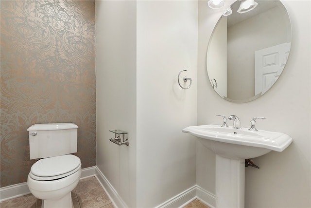 bathroom with toilet and tile patterned floors