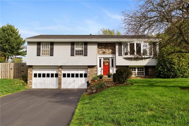 raised ranch featuring a front yard and a garage